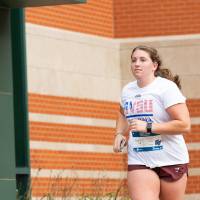 Participant nearing finish line wearing GVSU shirt